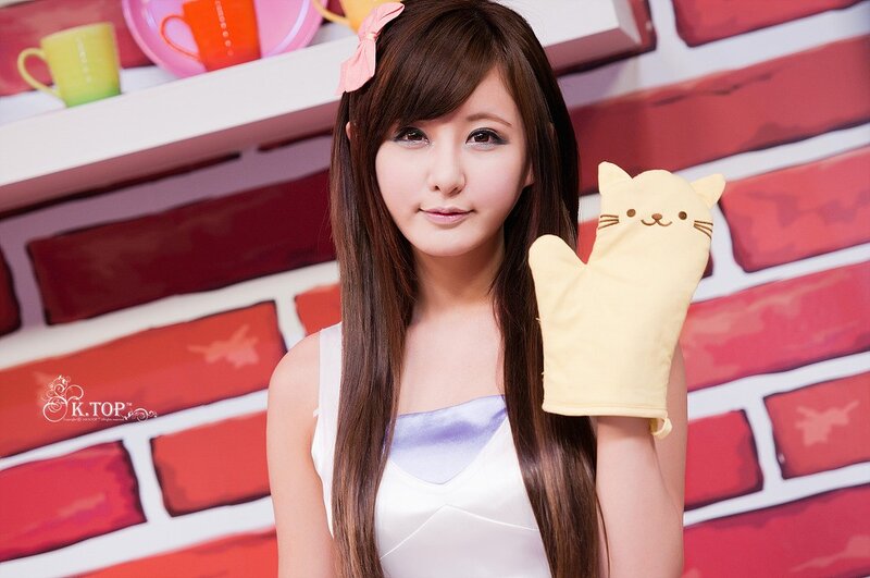 woman holding cat oven mitt
