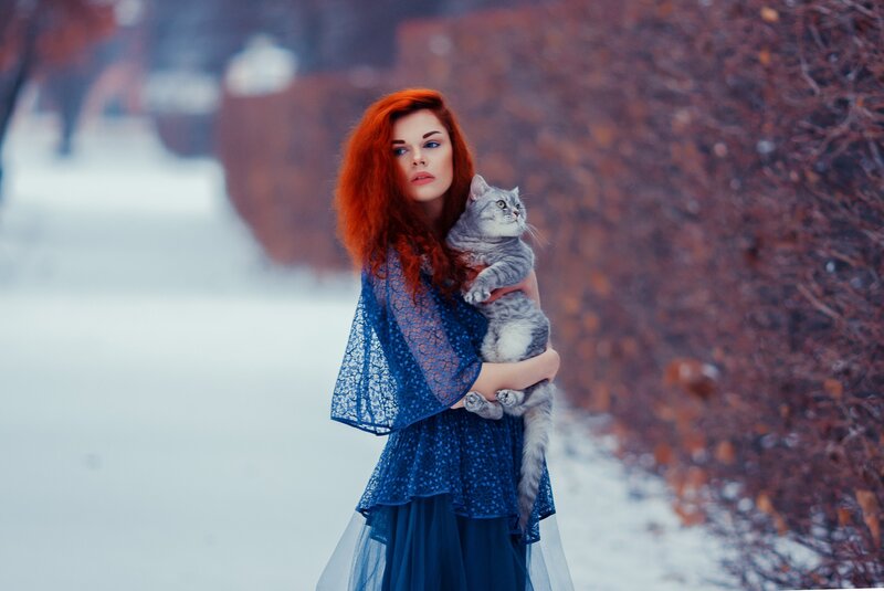 Woman Holding Cat — Red, Dramatic, Winter