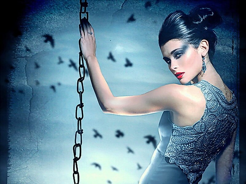 woman holding chain in dark setting