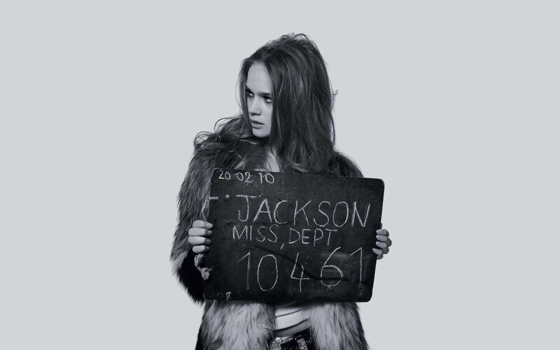 Woman holding chalkboard sign