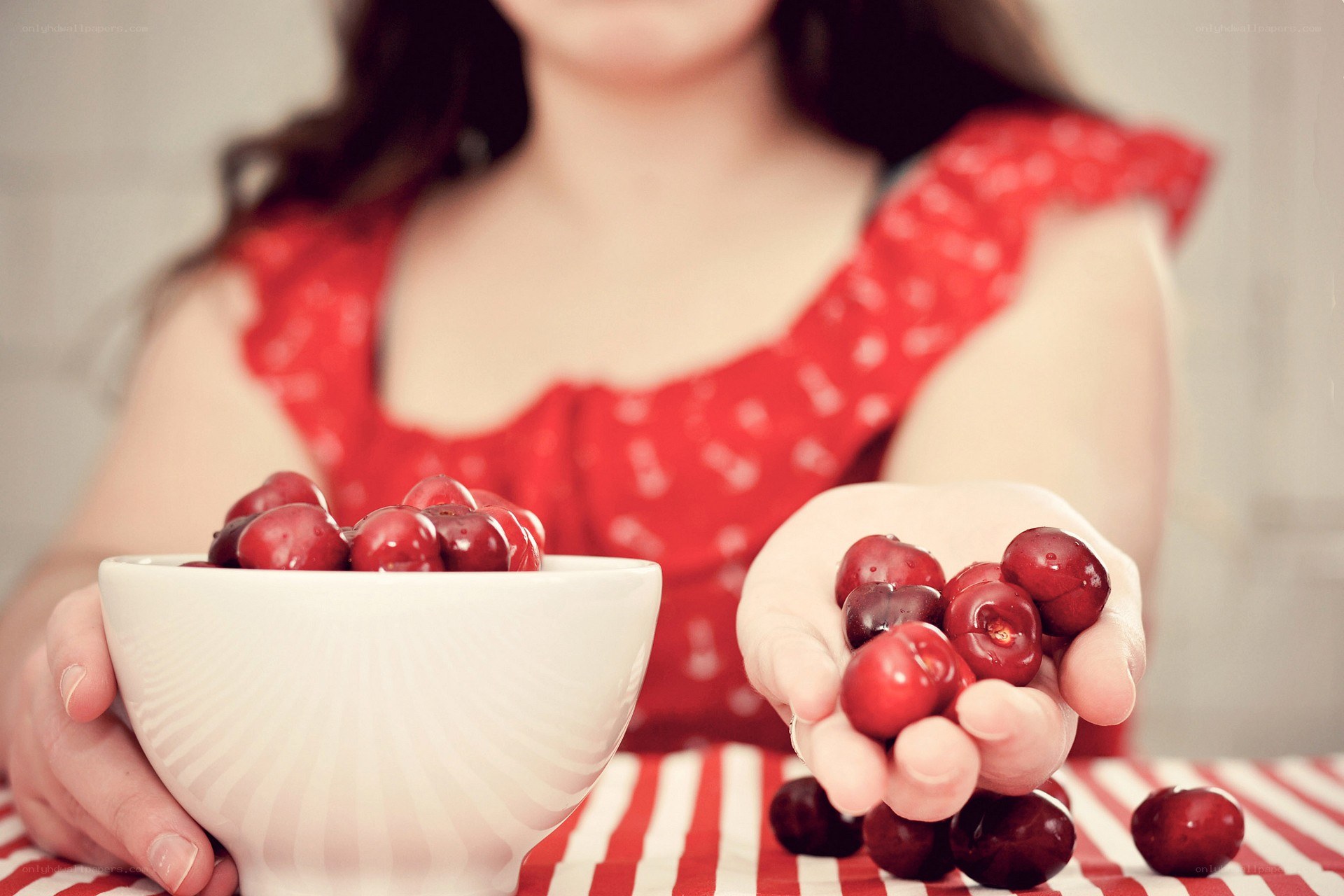 woman holding cherries