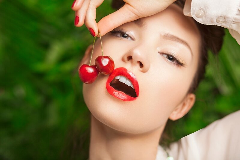 Woman Holding Cherries — Red