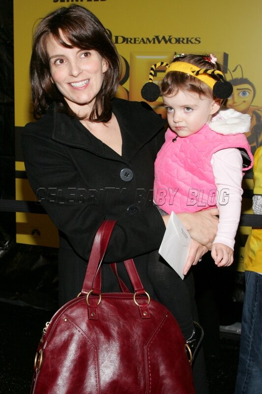 woman holding child at event