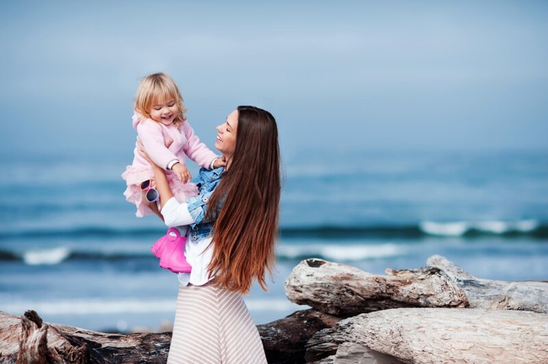 Woman Holding Child — Blue, Serene, Afternoon, Photograph