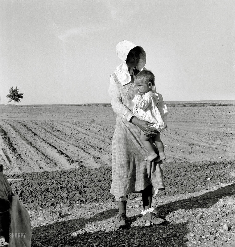 Woman holding child in field