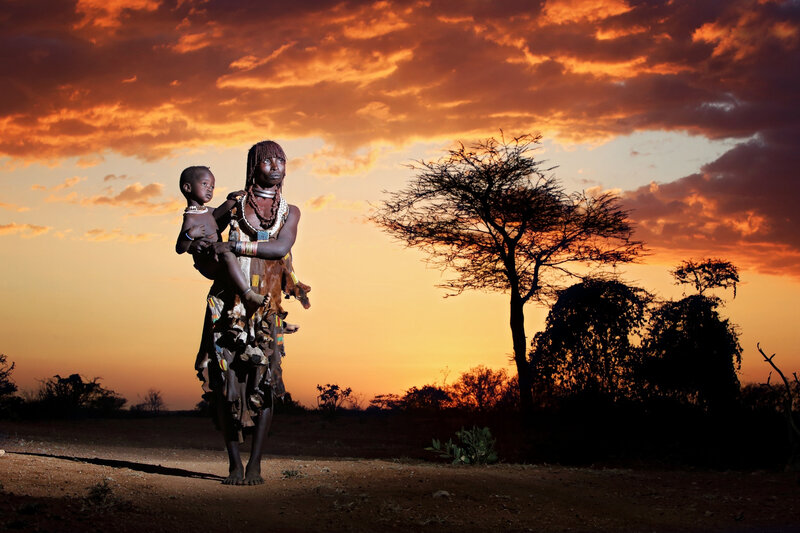 Woman Holding Child — Orange, Dramatic