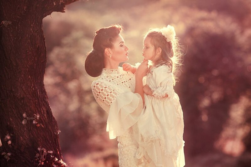 Woman Holding Child — White, Serene, Sunset