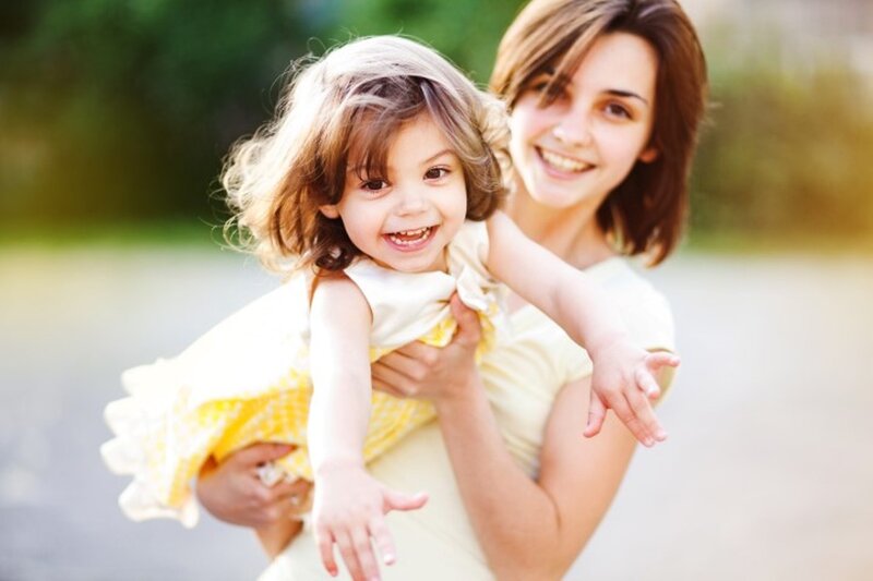Woman Holding Child — Yellow, Happy
