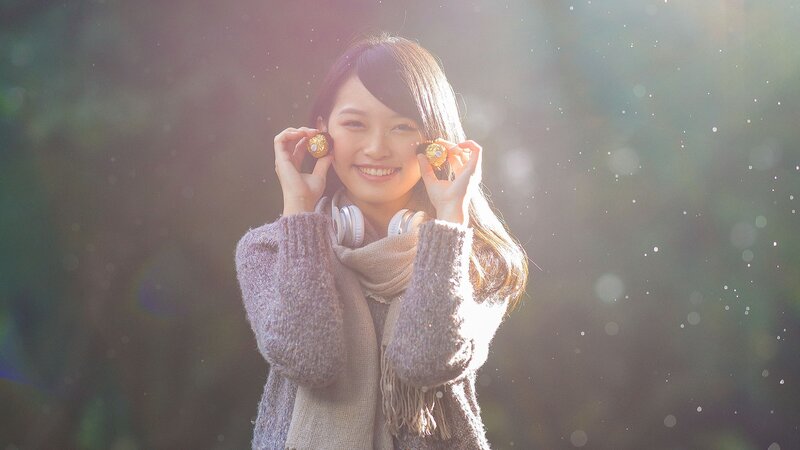 woman holding chocolates in sunlight