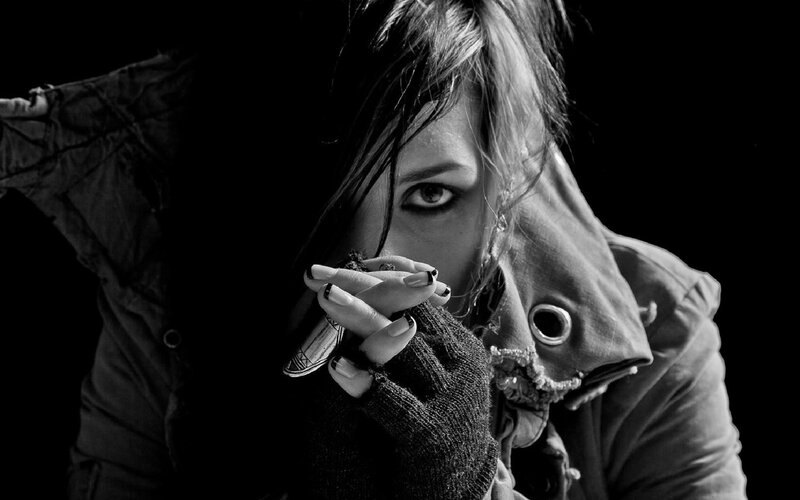 woman holding cigarette in dark