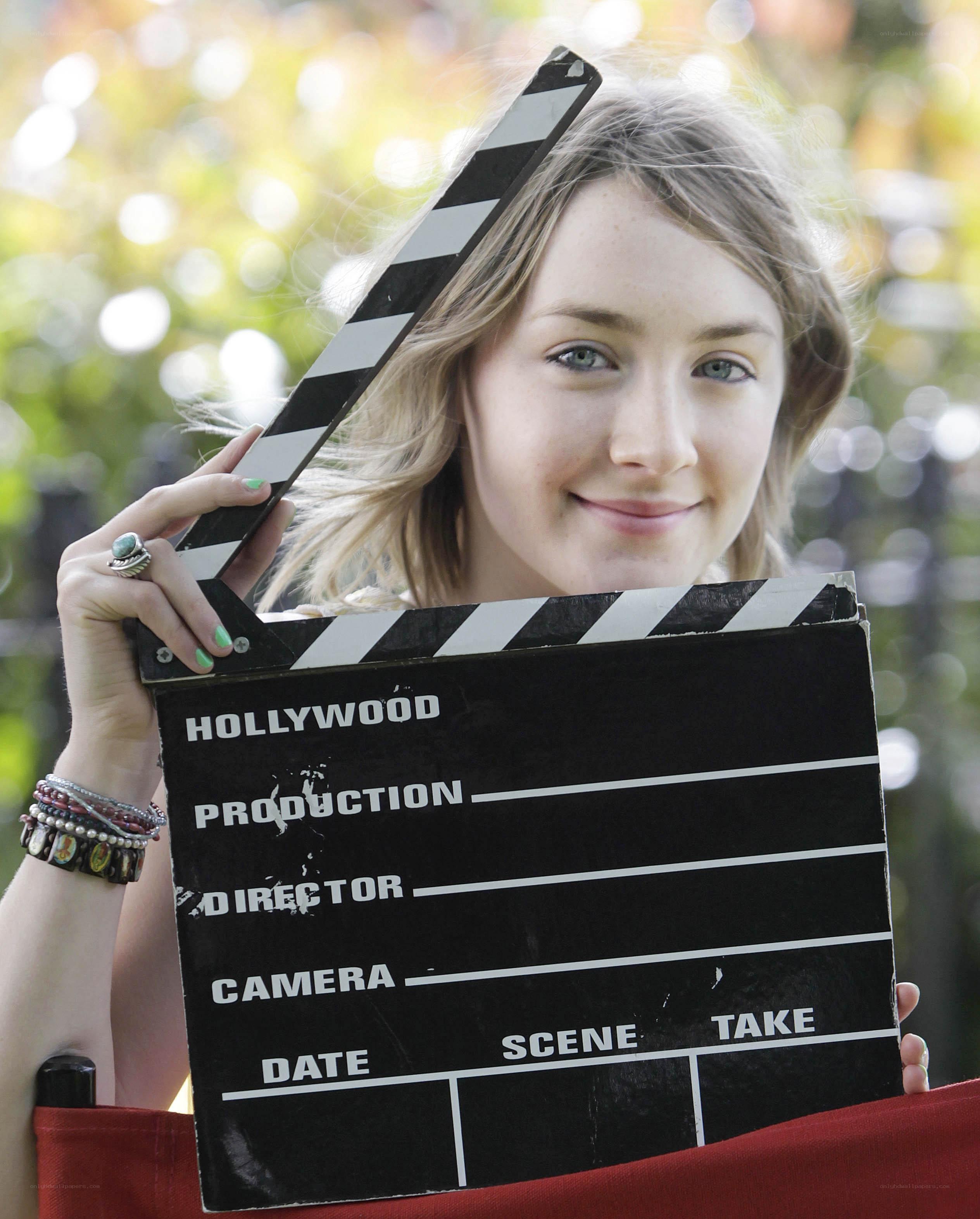 Woman holding clapperboard