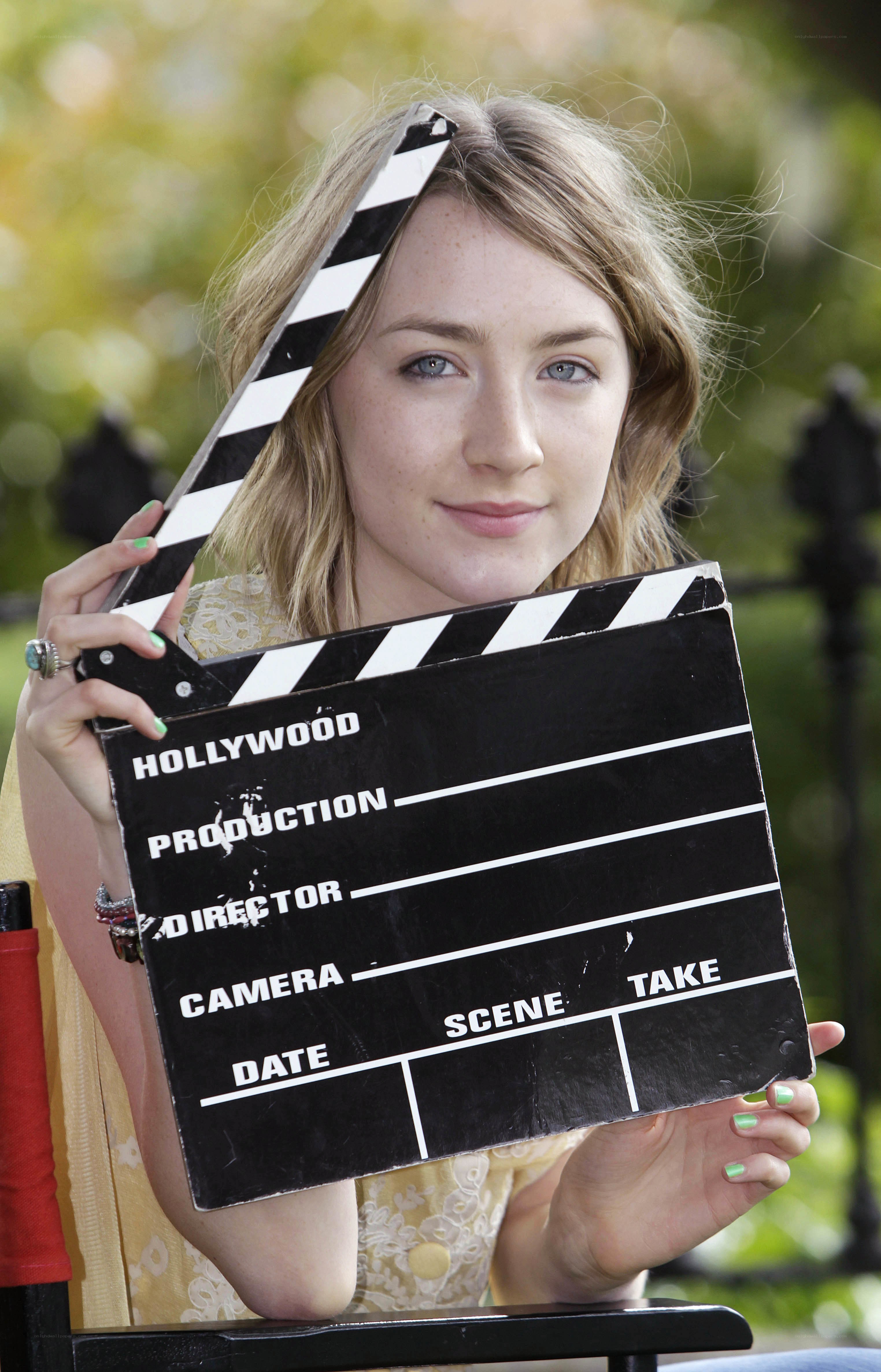 Woman holding clapperboard