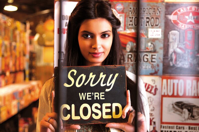 Woman holding closed sign