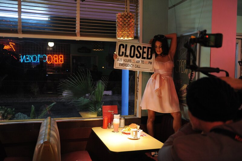 Woman holding closed sign in diner