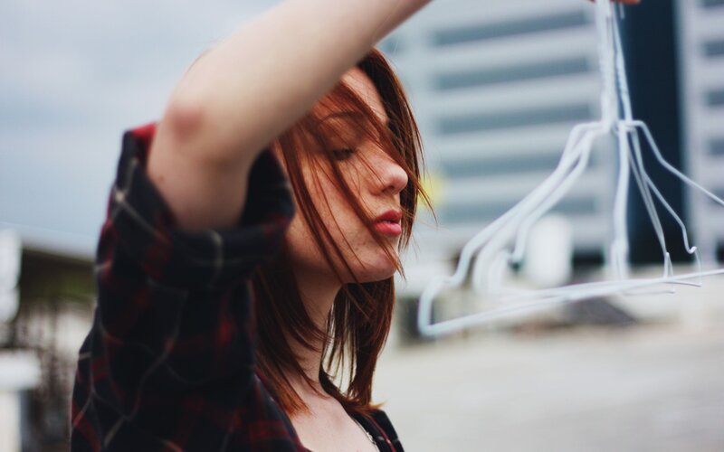 woman holding clothes hangers
