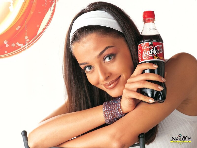 woman holding coca-cola bottle
