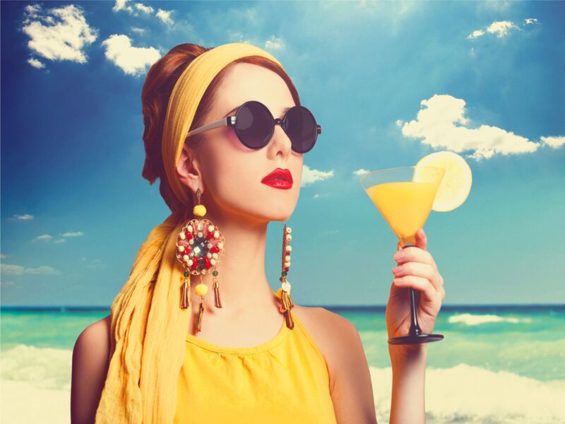 Woman Holding Cocktail — Yellow