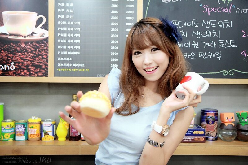 Woman holding coffee and pastry