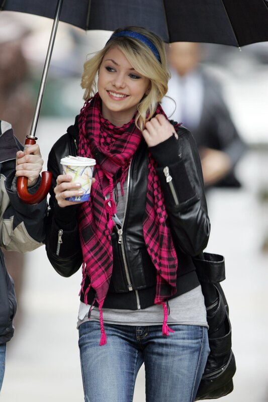 woman holding coffee and umbrella