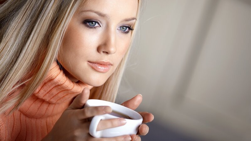 woman holding coffee cup