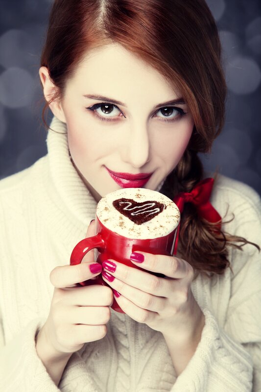woman holding coffee cup