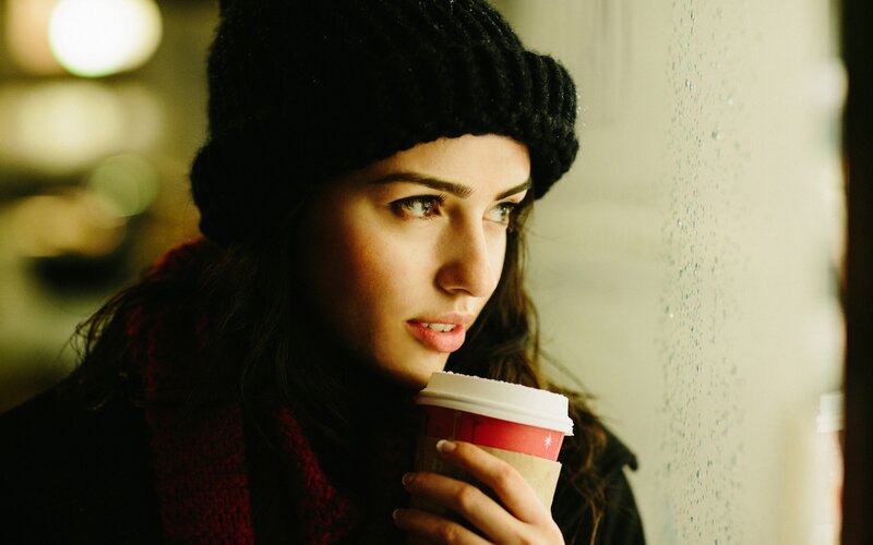 woman holding coffee cup