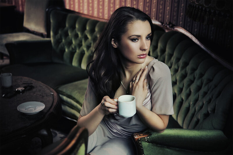 Woman Holding Coffee Cup — Green, Contemplative