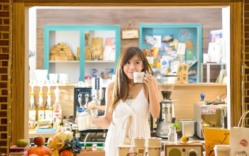 Woman holding coffee cup in cafe