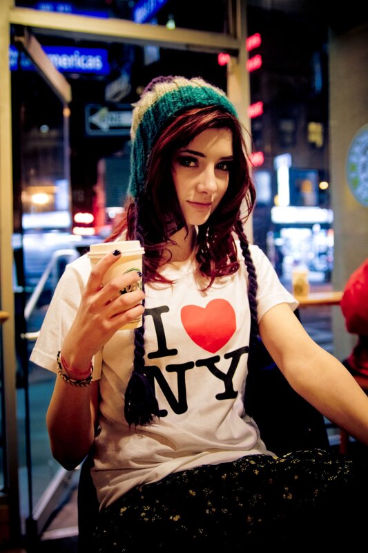 woman holding coffee in city