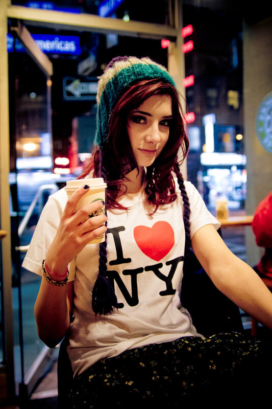 woman holding coffee in city