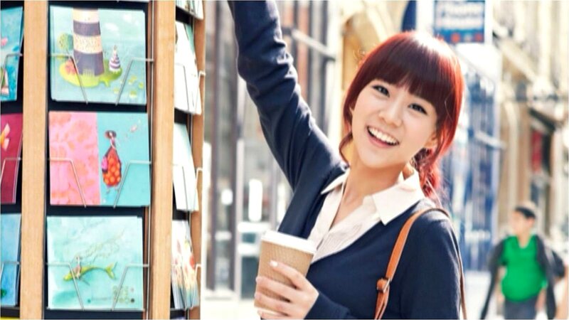 woman holding coffee on street