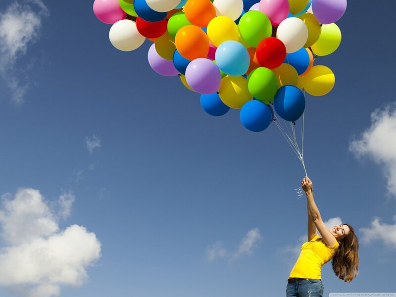 Woman holding colorful balloons