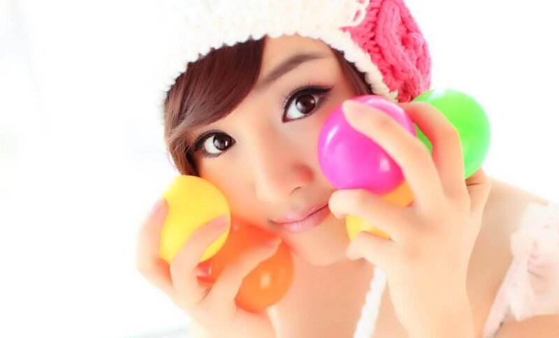 woman holding colorful balls