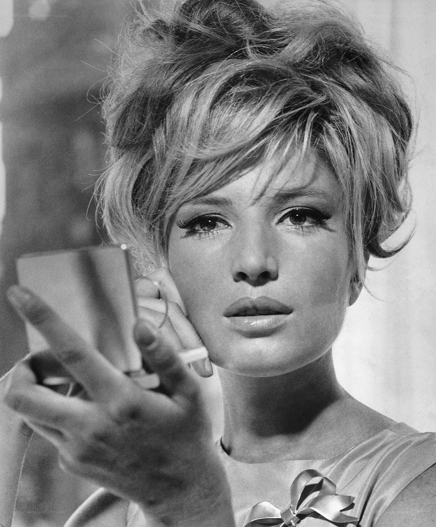 woman holding compact mirror