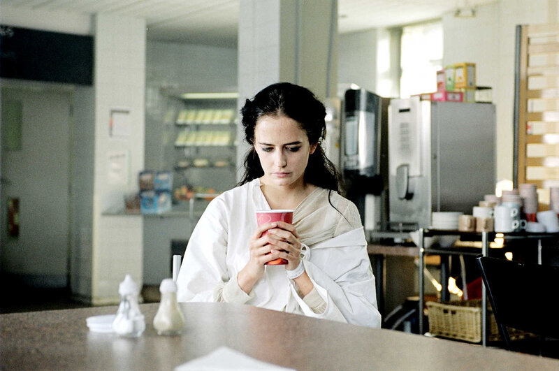 Woman holding cup in cafeteria
