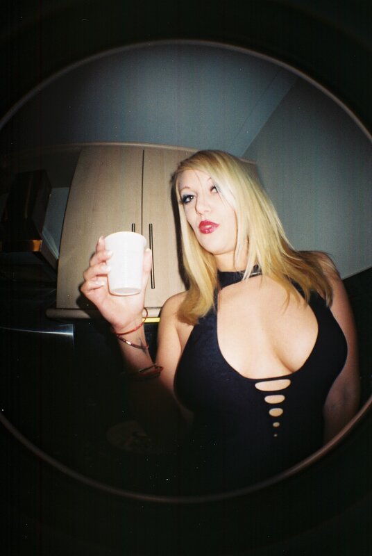 Woman holding cup in mirror