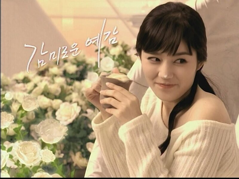 woman holding cup with flowers