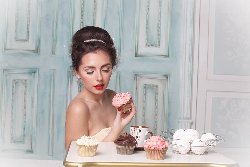 Woman Holding Cupcake — Blue, Elegant