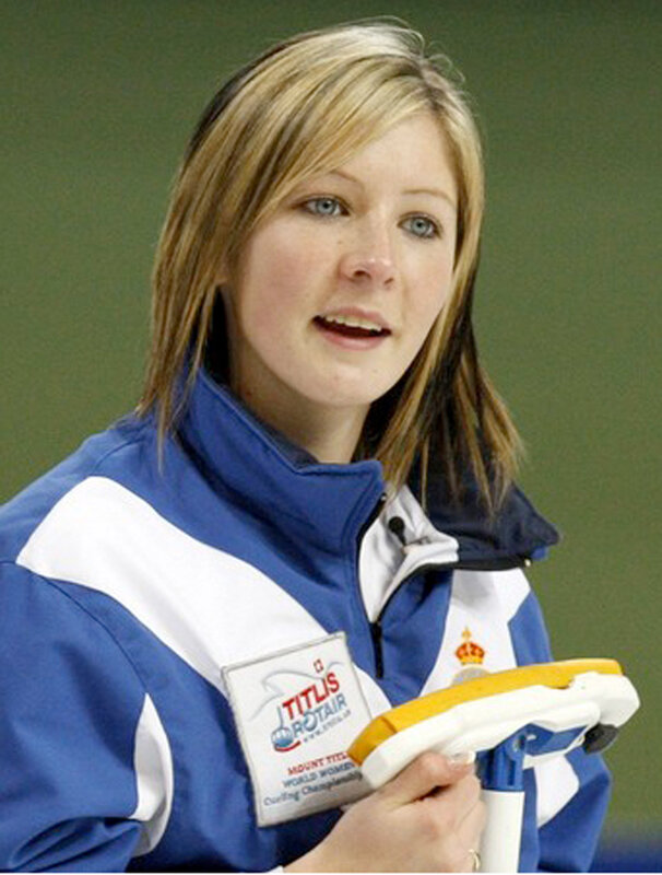woman holding curling broom