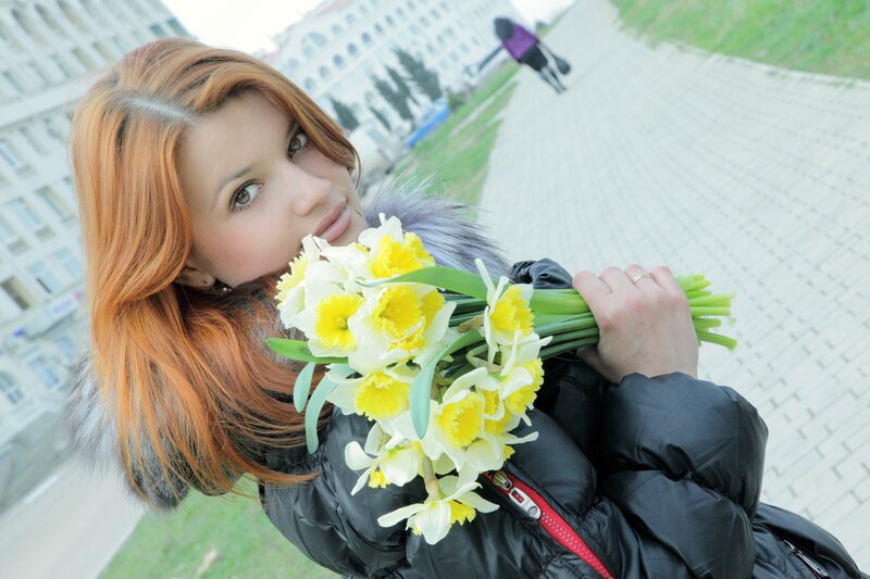 Woman holding daffodils outdoors