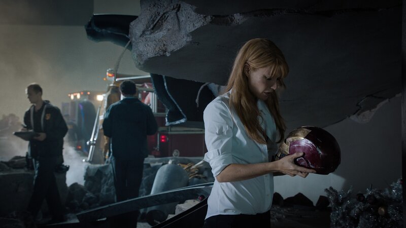 woman holding damaged helmet