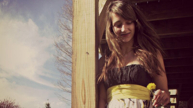 woman holding dandelion outdoors