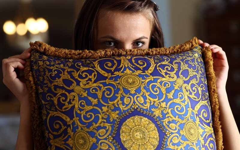 woman holding decorative pillow