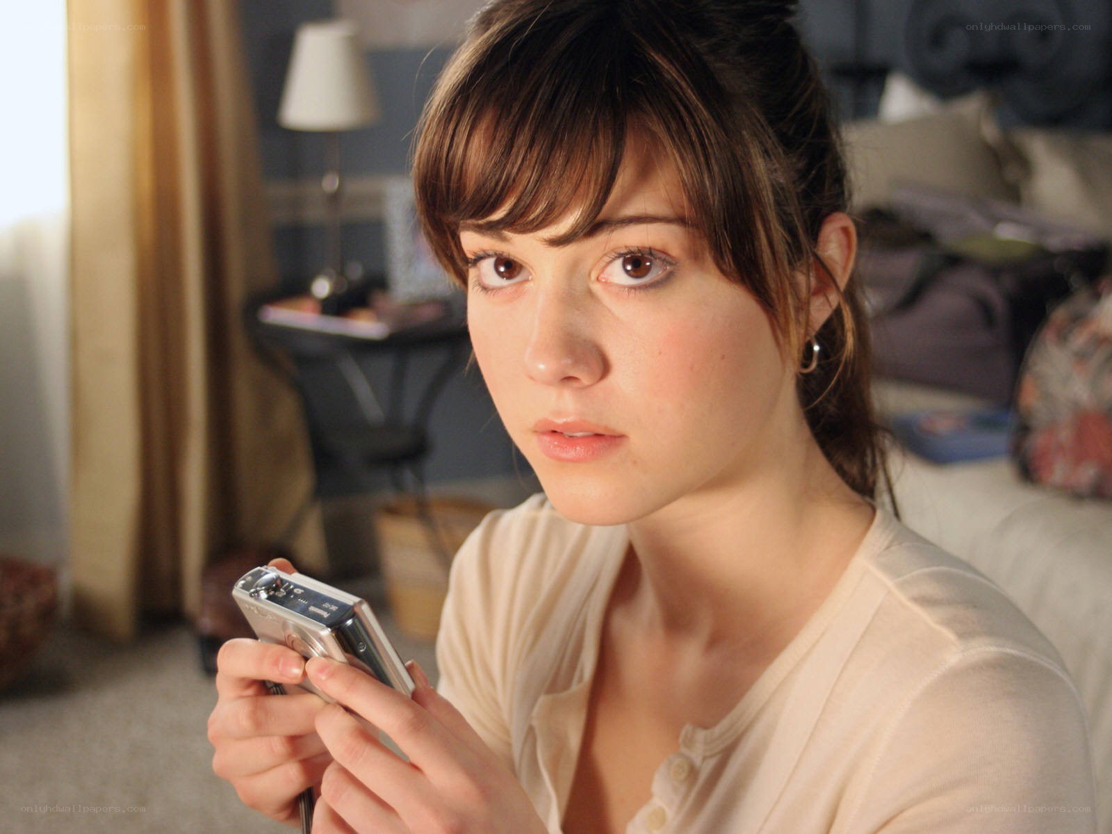 woman holding digital camera