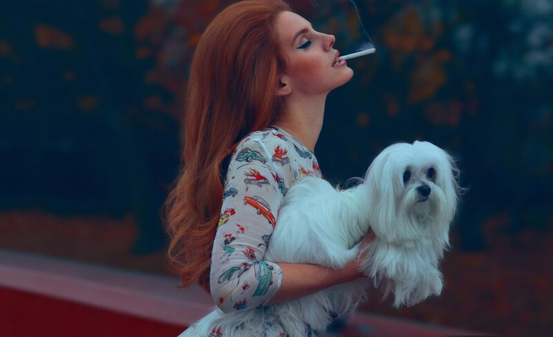 woman holding dog and smoking