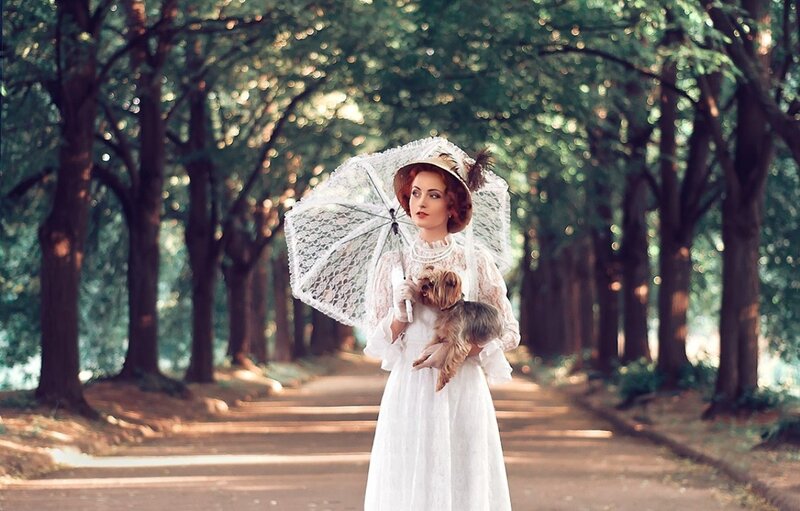 Woman Holding Dog and Umbrella