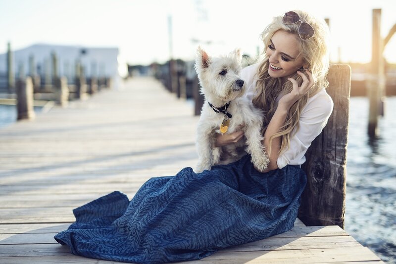 Woman Holding Dog — Blue, Serene, Afternoon, Photograph