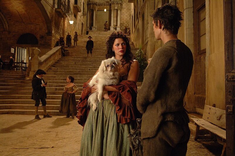 Woman holding dog on stairs