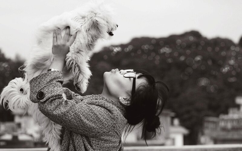 woman holding dog up