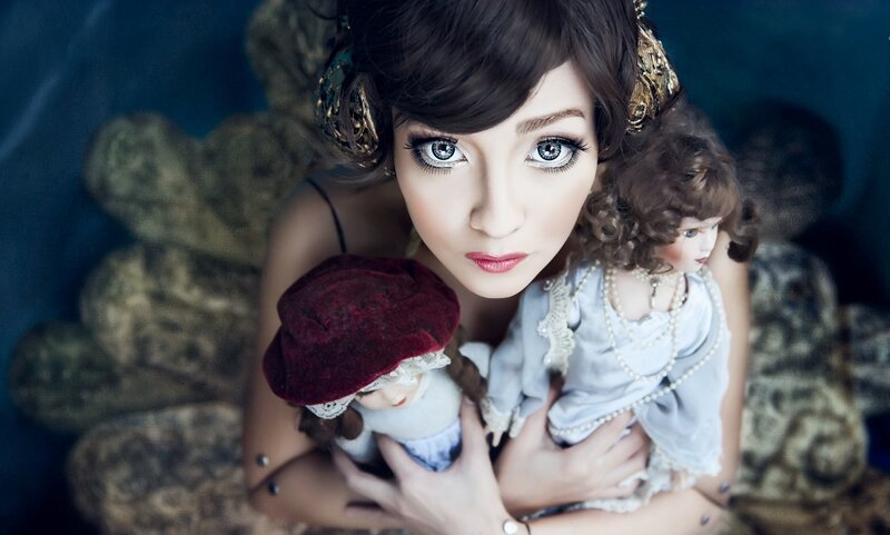 Woman Holding Dolls